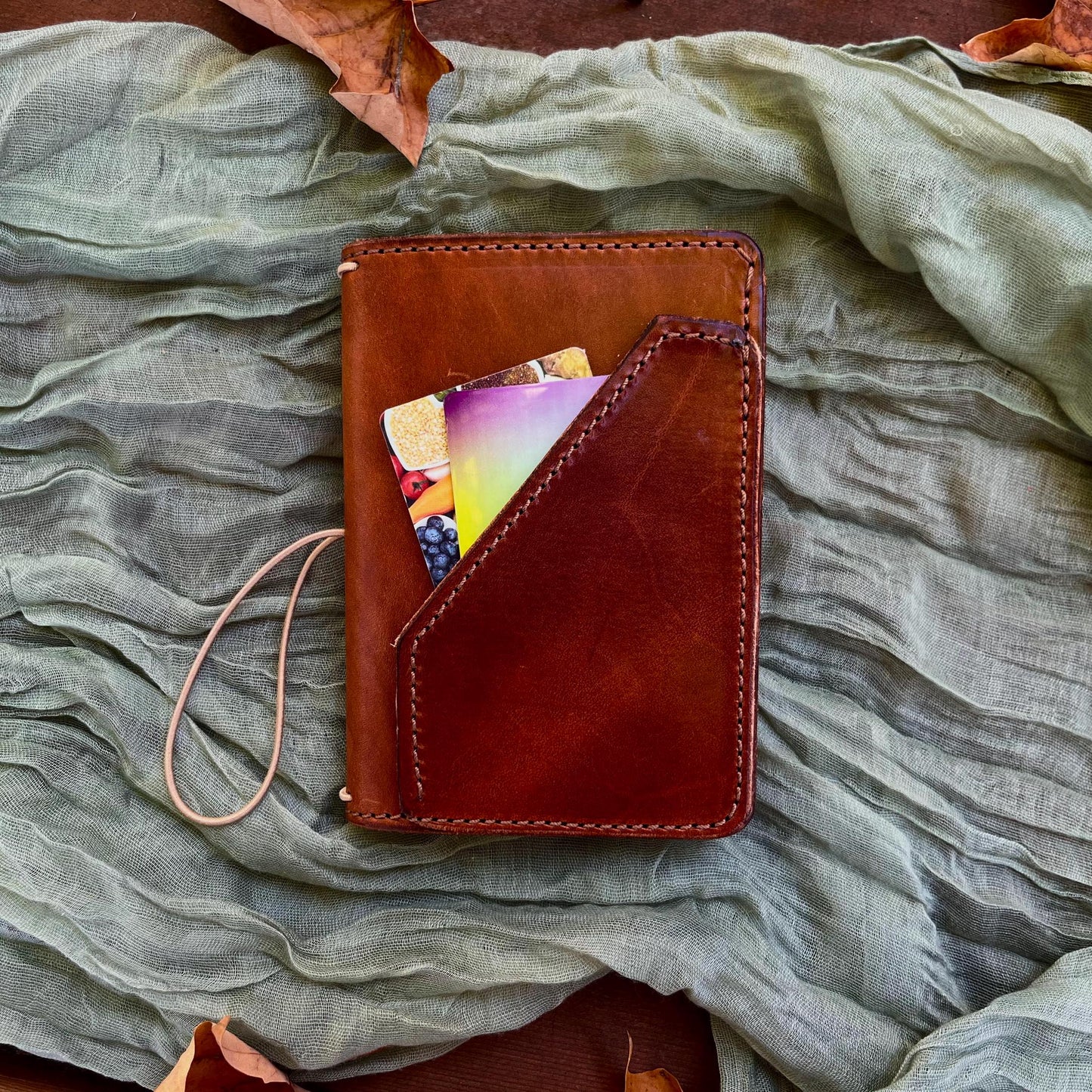 Pocket Traveler&#39;s Notebook with front outside pocket. Tan elastic cord. Holds 3 inserts.